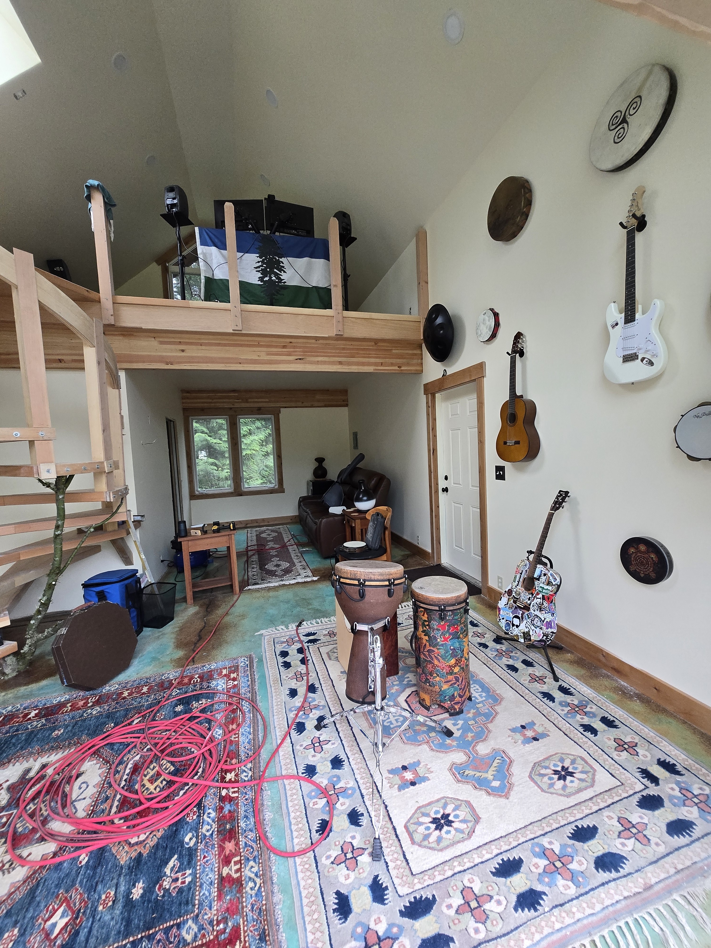 Alpenglow Studio — loft, instrument wall and teal concrete floor
